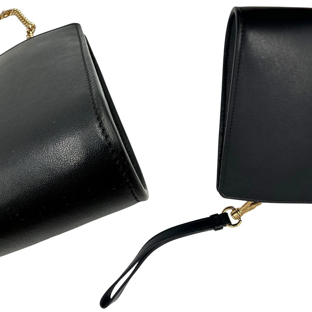 Angoli di una borsa Tod's in pelle nera con parti metalliche dorate; munita di una tracolla in catena non amovibile e non regolabile e di un polsino staccabile in pelle. Completa di doppie dustbag.