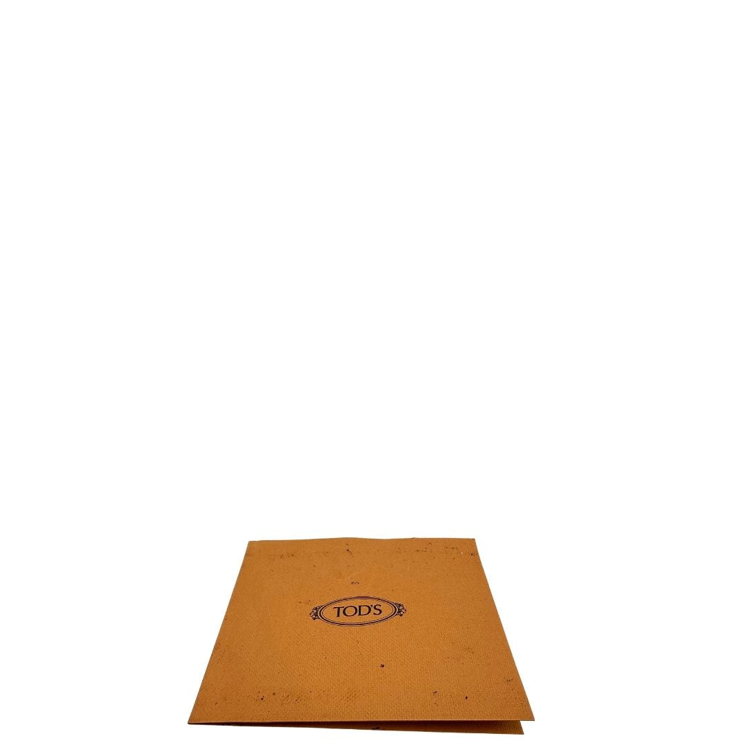 Cartellino di una borsa Tod's in pelle nera con parti metalliche dorate; munita di una tracolla in catena non amovibile e non regolabile e di un polsino staccabile in pelle. Completa di doppie dustbag.