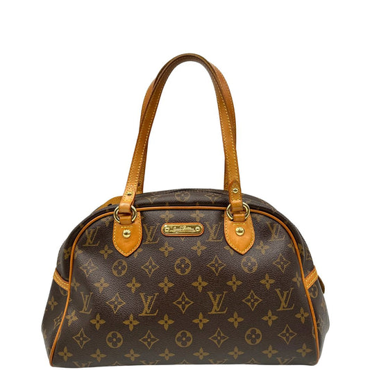 Front di una borsa Louis Vuitton in canvas marrone monogram con finiture in vacchetta naturale e parti metalliche dorate; munita di doppi manici, da portare a spalla. Completa di dustbag e lucchetto. Indossabile a mano.