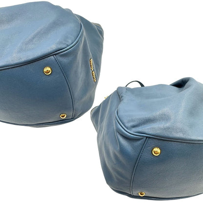 angoli Borsa Miu Miu in pelle blu con parti metalliche dorate; munita di doppi manici, indossabile a spalla. Completa di dustbag, di lusso, originale, ottime condizioni. 