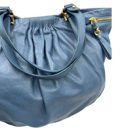 manici Borsa Miu Miu in pelle blu con parti metalliche dorate; munita di doppi manici, indossabile a spalla. Completa di dustbag, di lusso, originale, ottime condizioni. 