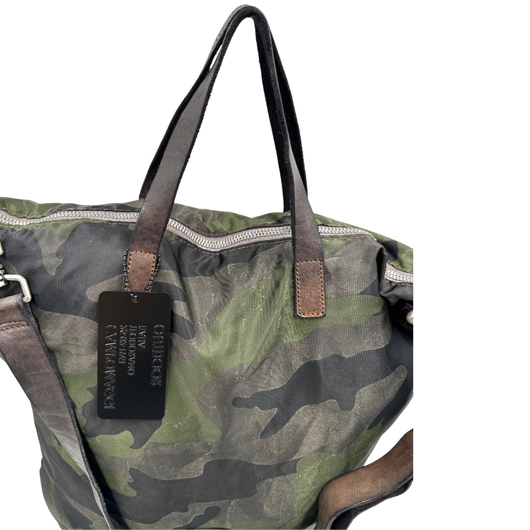 Vista manici di una tote Campomaggi in nylon trama camouflage, con finiture in pelle testa di moro e parti metalliche argentate. Munita di tracolla amovibile e regolabile. Completa di dustbag.