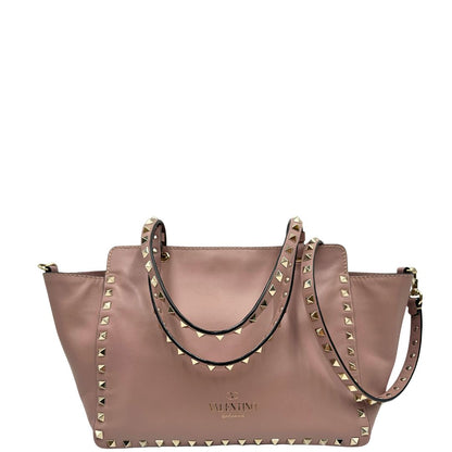 retro Borsa Valentino Garavani in pelle rosa con parti metalliche dorate; impreziosita da borchie piramidali e munita di doppi manici e una tracolla amovibile. Completa di dustbag, di lusso, originale, usata. 