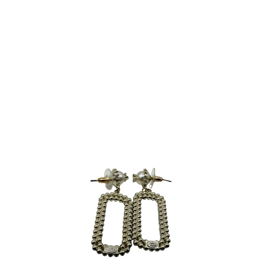 Orecchini Chanel dal design rettangolare pendente composto da piccole perle disposte in doppia fila. La parte superiore è decorata da una perla più grande con il logo CC in metallo. Full set.