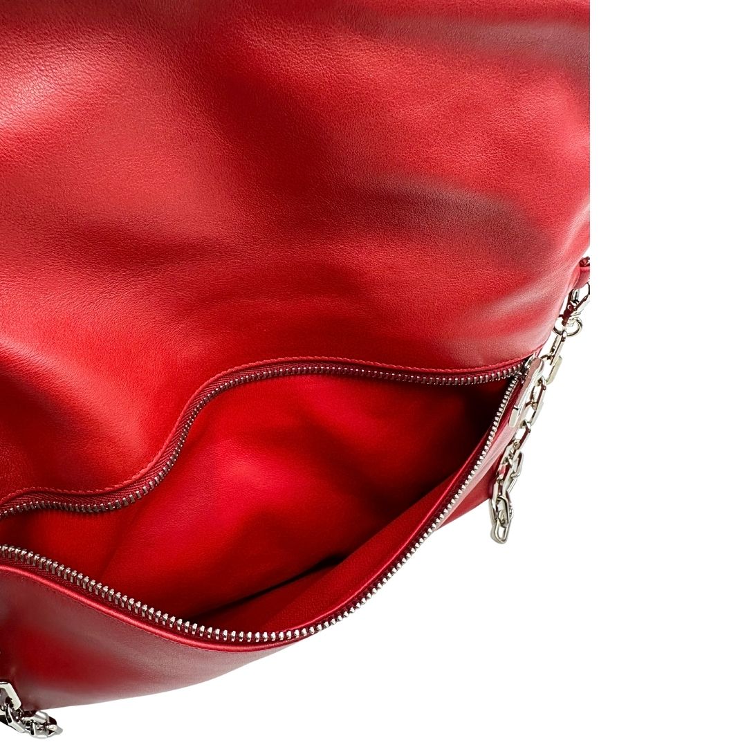 Interno di una borsa a tracolla Prada in pelle rossa, munita di una tracolla in catena e pelle amovibile e regolabile. Completa di scatola.