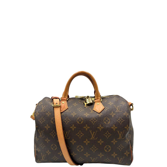 Front di una borsa Speedy 30 in canvas marrone monogram con finiture in vacchetta naturale e parti metalliche dorate; munita di doppi manici stondati e una tracolla amovibile e regolabile. Completa di corredo, lucchetto e chiavi.