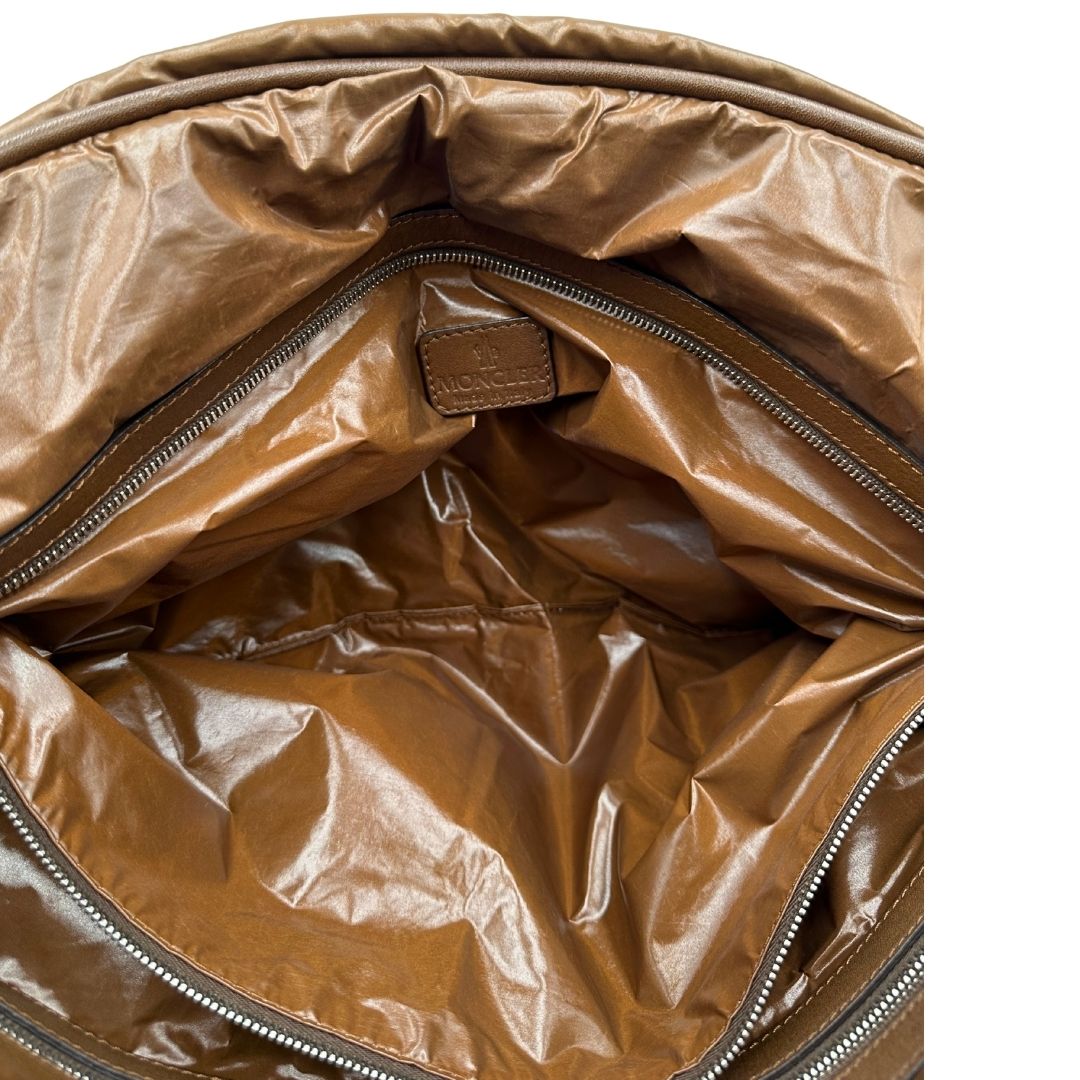 Interno di una borsa Moncler in poliuretano color caramello effetto imbottito e finiture in pelle tono su tono, con metalleria dorata. Munita di cartellino. Da indossare a spalla.