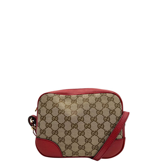 Front di una Borsa Gucci in tessuto GG beige con finiture in pelle martellata rossa e parti metalliche dorate; munita di una tracoll regolabile. Completa di dustbag. Originale, usata, di lusso, in ottime condizioni.