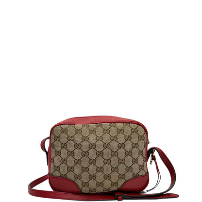 Retro di una Borsa Gucci in tessuto GG beige con finiture in pelle martellata rossa e parti metalliche dorate; munita di una tracoll regolabile. Completa di dustbag. Originale, usata, di lusso, in ottime condizioni.