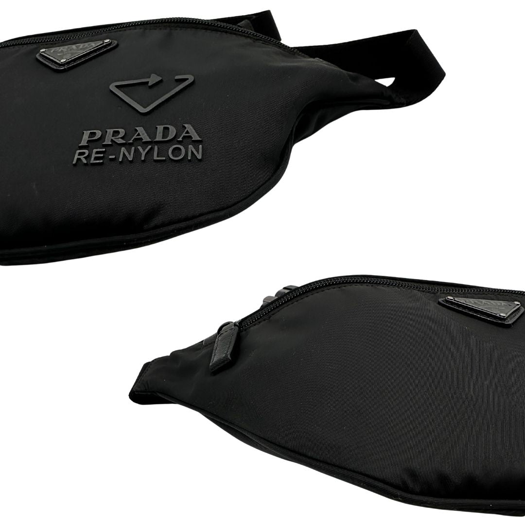 Angoli di un marsupio Prada in Re-Nylon nero con dettagli in pelle tono su tono, logo gommato sul front e parti in metallo argentato. Leggermente regolabile, indossabile a marsupio o cross body.