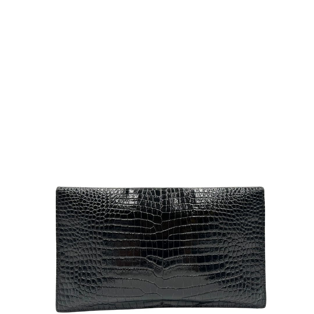 Retro di una pochette Saint Laurent in pelle nera lucida effetto cocco, impreziosita dal logo Cassandre sul front in metallo argentato. Munita di dustbag.