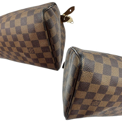 Angoli di una borsa Louis Vuitton in canvas Damier Ébène con parti metalliche dorate; munita di doppi manici stondati, da portare a mano. Completo di scatola logata, lucchetto e chiavi.