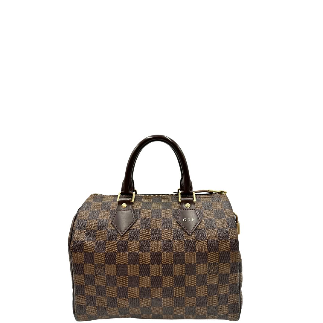 Front di una borsa Louis Vuitton in canvas Damier Ébène con parti metalliche dorate; munita di doppi manici stondati, da portare a mano. Completo di scatola logata, lucchetto e chiavi.