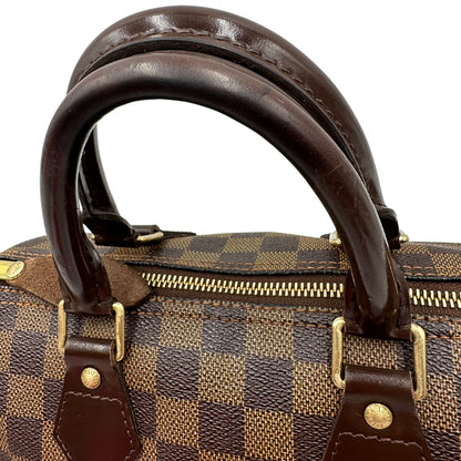 Manici di una borsa Louis Vuitton in canvas Damier Ébène con parti metalliche dorate; munita di doppi manici stondati, da portare a mano. Completo di scatola logata, lucchetto e chiavi.