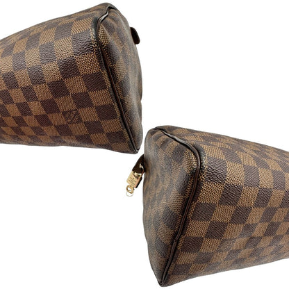 Angoli di una borsa Louis Vuitton in canvas Damier Ébène con parti metalliche dorate; munita di doppi manici stondati, da portare a mano. Completo di scatola logata, lucchetto e chiavi.