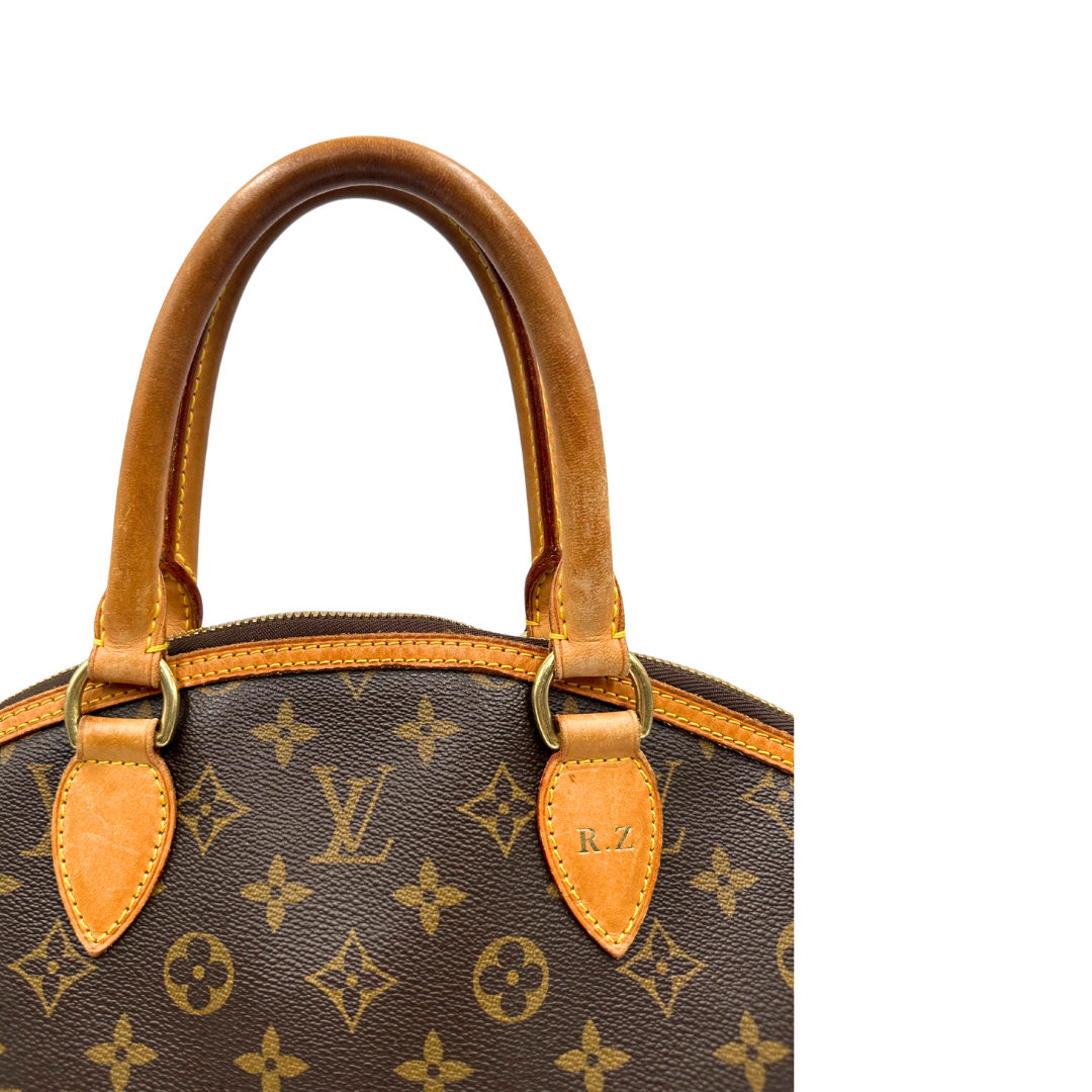 Manici di una Borsa Louis Vuitton in canvas marrone monogram con finiture in vacchetta naturale e parti metalliche dorate. Munita di doppi manici stondati. Completa di dustbag, lucchetto e chiavi. Originale, usata, di lusso, in ottime condizioni.