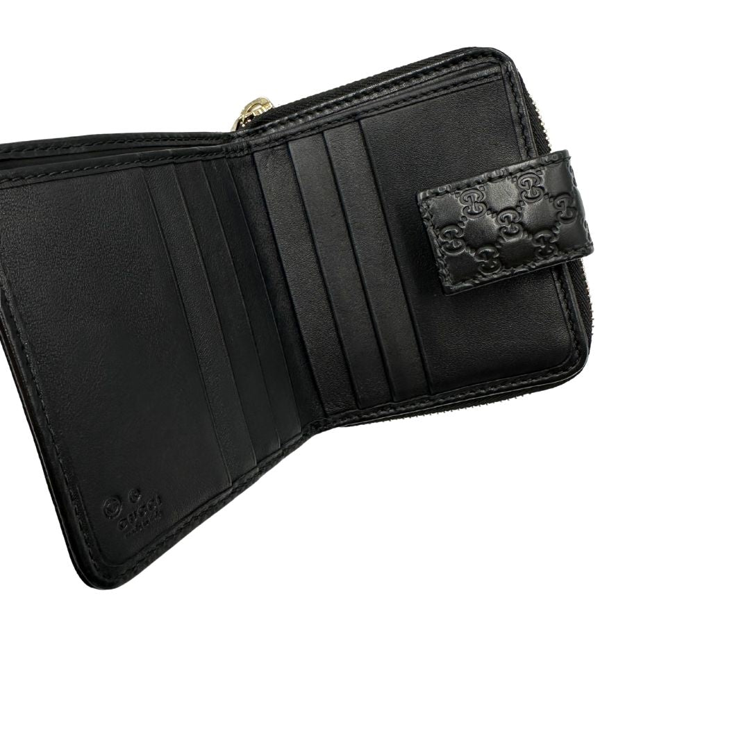 Interno di un Portafoglio Gucci in pelle nera GG con parti metalliche dorate. Completo di scatola. Originale, usato, di lusso, in ottime condizioni.