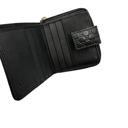 Interno di un Portafoglio Gucci in pelle nera GG con parti metalliche dorate. Completo di scatola. Originale, usato, di lusso, in ottime condizioni.