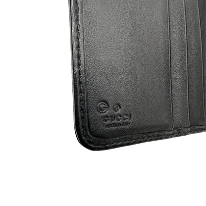 Portafoglio Gucci in pelle nera GG con parti metalliche dorate. Completo di scatola. Originale, usato, di lusso, in ottime condizioni.