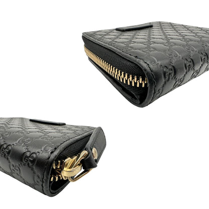 Angoli di un Portafoglio Gucci in pelle nera GG con parti metalliche dorate. Completo di scatola. Originale, usato, di lusso, in ottime condizioni.