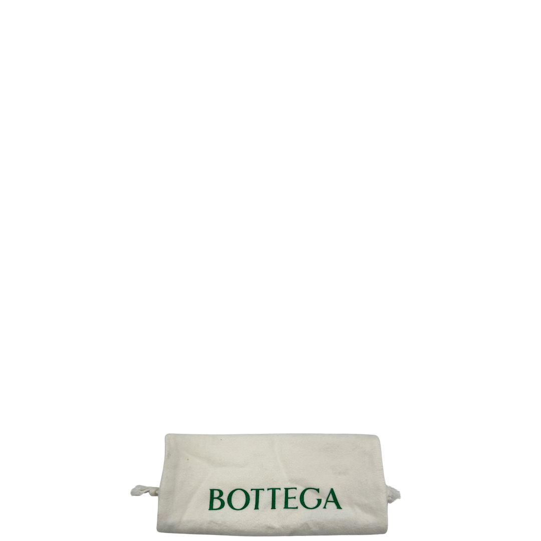 Dustbag di una borsa Bottega Veneta in pelle intrecciata con iconico nodo sul manico color crema, con parti metalliche dorate.