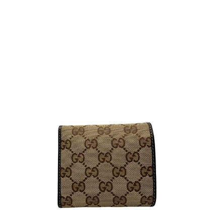 retro Portafoglio Gucci in tessuto beige GG con finiture in pelle marrone e parti metalliche dorate. Completo di busta e dustbag, di lusso, originale, ottime condizioni. 