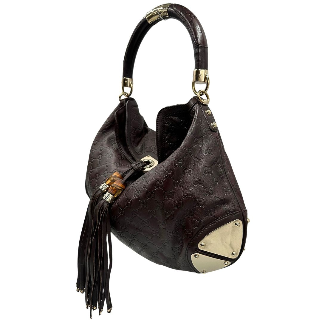 lato Borsa Gucci in pelle marrone GG con parti metalliche dorate; munita di un manico rigido, impreziosita da doppia nappa con dettaglio bamboo e angoli finiture metalliche, di lusso, originale, ottime condizioni 