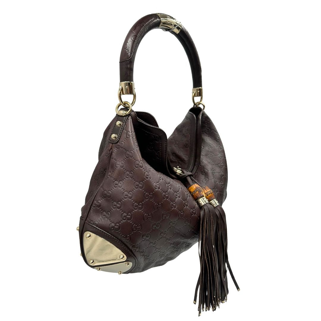 lato Borsa Gucci in pelle marrone GG con parti metalliche dorate; munita di un manico rigido, impreziosita da doppia nappa con dettaglio bamboo e angoli finiture metalliche, di lusso, originale, ottime condizioni 