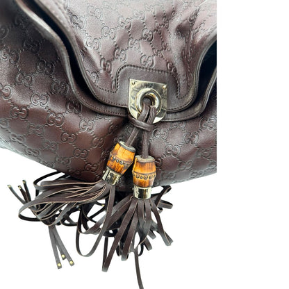 bamboo dettaglio Borsa Gucci in pelle marrone GG con parti metalliche dorate; munita di un manico rigido, impreziosita da doppia nappa con dettaglio bamboo e angoli finiture metalliche, di lusso, originale, ottime condizioni 