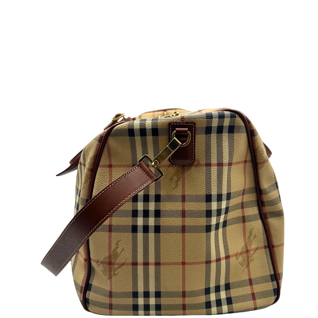 lato Borsone Burberry in canvas trama tartan con finiture in pelle marroni e parti metalliche dorate; munito di doppi manici stondati e una tracolla amovibile. Completo di lucchetto e chiavi, di lusso, originale, ottime condizioni. 