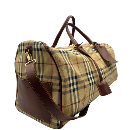 lato Borsone Burberry in canvas trama tartan con finiture in pelle marroni e parti metalliche dorate; munito di doppi manici stondati e una tracolla amovibile. Completo di lucchetto e chiavi, di lusso, originale, ottime condizioni. 