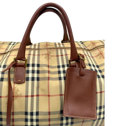 manici Borsone Burberry in canvas trama tartan con finiture in pelle marroni e parti metalliche dorate; munito di doppi manici stondati e una tracolla amovibile. Completo di lucchetto e chiavi, di lusso, originale, ottime condizioni.