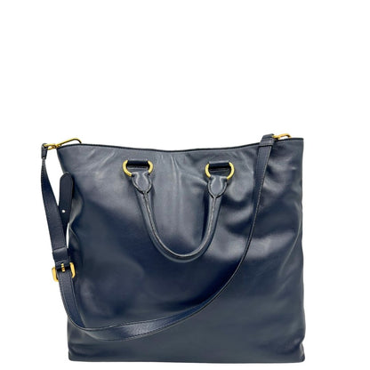 Retro di una Borsa Prada in pelle blu notte con parti metalliche dorate; munita di un accessorio porta address, doppi manici stondati e una tracolla amovibile e regolabile. Indossabile a mano oppure a tracolla. Originale, usata, di lusso, in ottime condizioni.