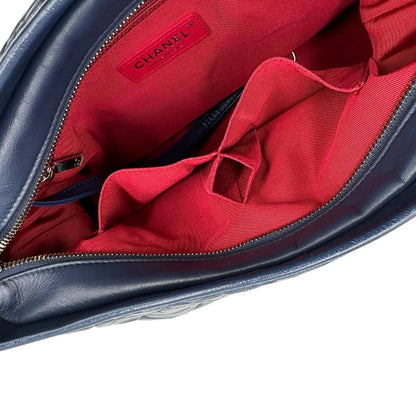 Interno di una borsa Chanel Gabrielle in pelle matelassé blu navy con parti metalliche dorate e argentate. Munita di una tracolla in catena e pelle intrecciata con spallaccio. Tirante delle cerniera impreziosito dall'iconico logo CC in metallo dorato, completa di corredo.