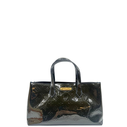 front Borsa Louis Vuitton in pelle verniciata marrone con riflessi che tendono al verde e parti metalliche dorate; munita di doppi manici, da portare a mano. Completa di corredo, di lusso, originale, ottime condizioni, usata.
