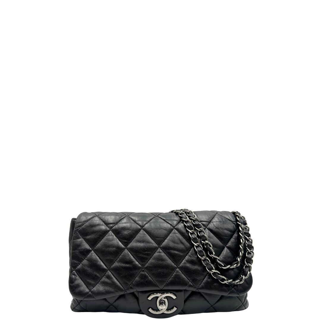 Front di una Borsa Chanel in pelle nera matelassè e parti metalliche argentate; munita di una tracolla scorrevole in catena e pelle. Indossabile a spalla e a tracolla. Completa di scatola. Originale, usata, di lusso, in condizioni eccellenti.