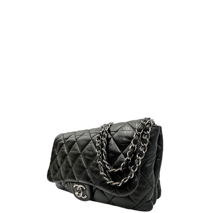 Lato sinistro di una Borsa Chanel in pelle nera matelassè e parti metalliche argentate; munita di una tracolla scorrevole in catena e pelle. Indossabile a spalla e a tracolla. Completa di scatola. Originale, usata, di lusso, in condizioni eccellenti.