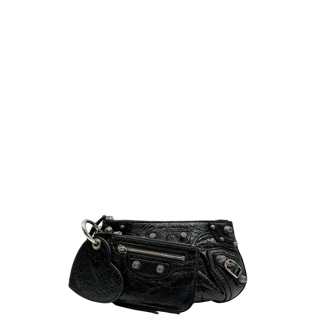 Front di una pochette Balenciaga in pelle effetto invecchiato nera, con parti metalliche argentate; munita di uno specchietto a forma di cuore, polsino amovibile e un mini porta monete e carte. Completa di dustbag.