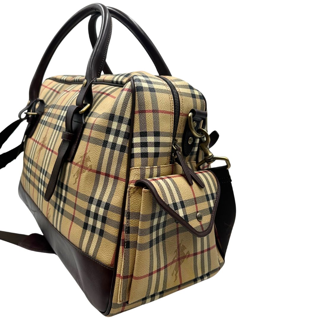 Laterale destro di un borsone Burberry in canvas trama tartan con finiture in pelle marrone testa di moro e parti metalliche dorate; munito di doppi manici stondati e una tracolla amovibile e regolabile.