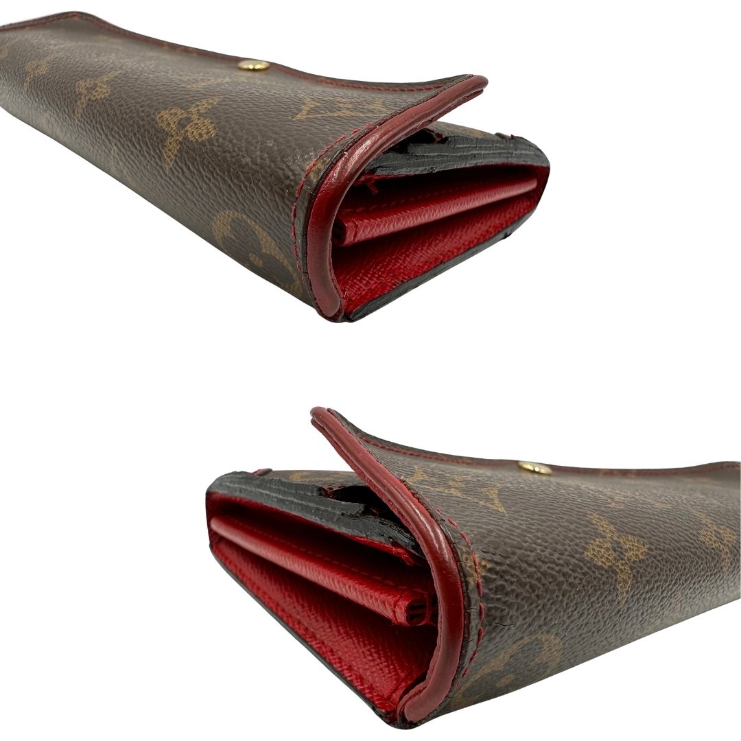 Portafoglio Louis Vuitton Sarah Retiro in canvas monogrammato marrone e finiture rosse, completo di corredo.