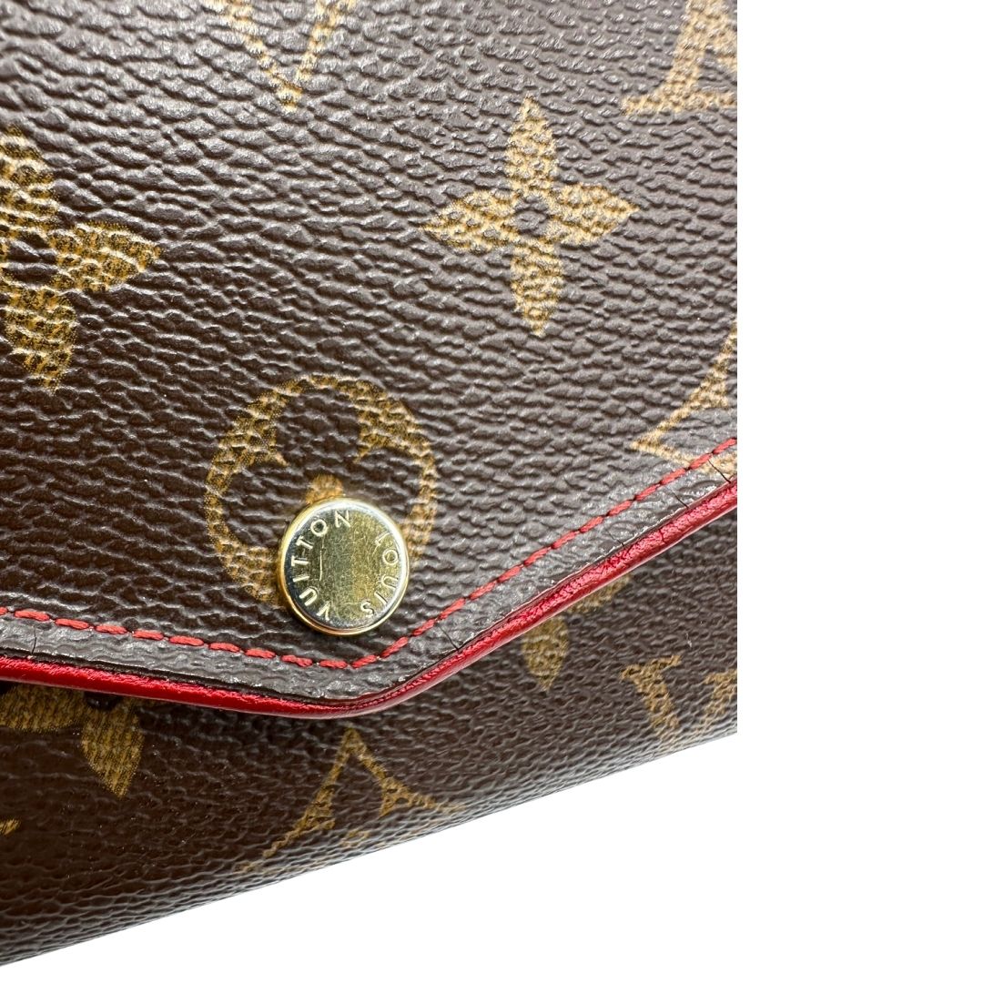 Portafoglio Louis Vuitton Sarah Retiro in canvas monogrammato marrone e finiture rosse, completo di corredo.