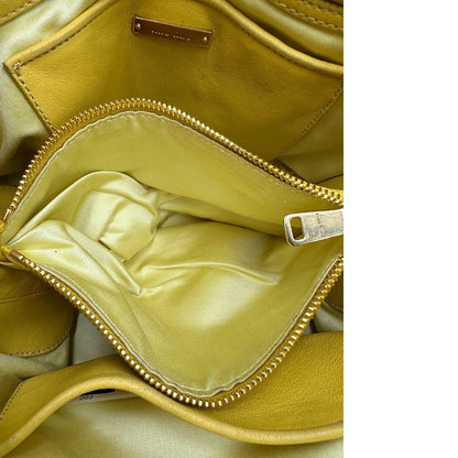 interno Borsa Miu Miu realizzata in pelle matelassè gialla con parti metalliche dorate; munita di doppi manici stondati e una tracolla amovibile e regolabile. Completa di dustbag, di lusso, originale, usata. 
