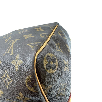 angolo Borsa Louis Vuitton in canvas marrone monogram con finiture in vacchetta naturale e parti metalliche dorate; munita di doppi manici stondati. Completa di lucchetto e chiavi, di lusso, originale, ottime condizioni, usato. 