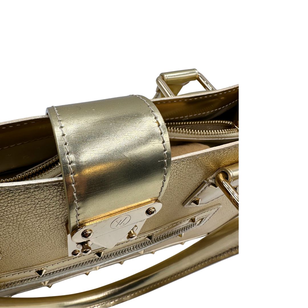 Chiusura di una borsa Louis Vuitton Suhali Le Fabuleux in pelle color oro con parti metalliche dorate. Munita di doppi manici stondati, impreziosita da una clochette porta chiavi. Completa di scatola e dustbag.