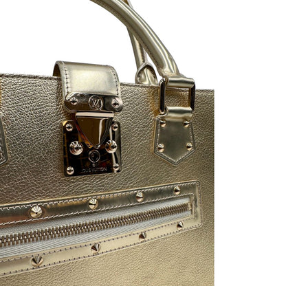 Chiusura di una borsa Louis Vuitton Suhali Le Fabuleux in pelle color oro con parti metalliche dorate. Munita di doppi manici stondati, impreziosita da una clochette porta chiavi. Completa di scatola e dustbag.