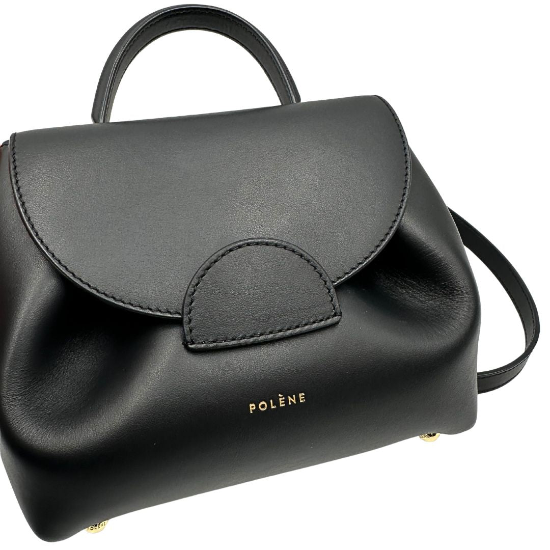 Borsa Polène in pelle nera con parti metalliche dorate; munita di un manico singolo stondato e una tracolla regolabile. Full set, di lusso, originale, ottime condizioni, usata.  