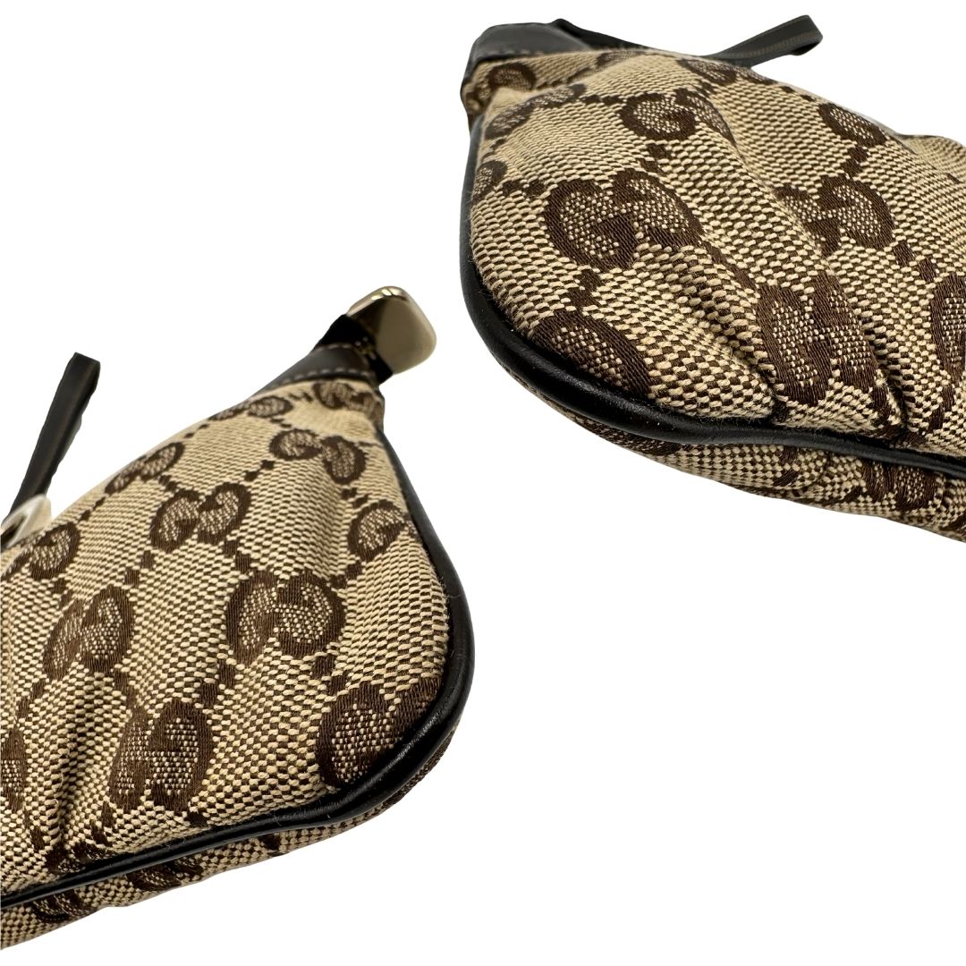 Angoli di una pochette Gucci in tessuto Gucci in tessuto GG beige con finiture in pelle marrone e parti metalliche dorate; munita di un polsino, da portare a mano. Completa di dustbag.