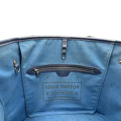 Interno di una borsa Louis Vuitton Neverfull MM in canvas base tie-dye nelle tonalità del blu e bianco, con finiture in pelle blu navy. Da un lato ha stampa Monogram Giant, dall'altra Monogram. Parti metalliche argentate; munita di doppi manici e dustbag, indossabile a spalla.