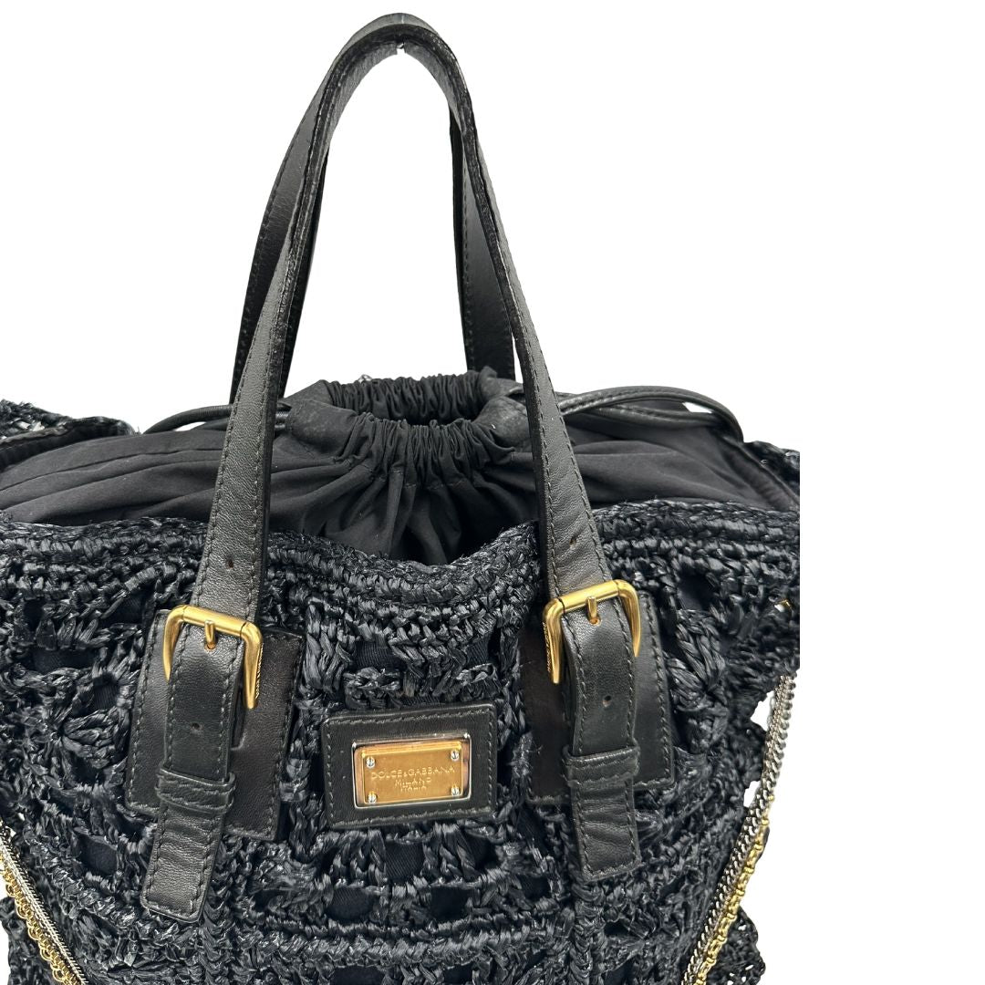 manici  Borsa Dolce & Gabbana in rafia e pelle nera, dalla struttura morbida e capiente, di lusso, originale, ottime condizioni, usata. 