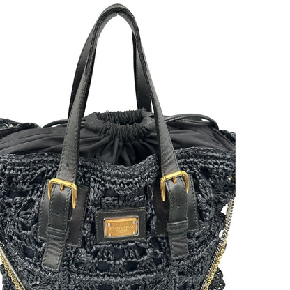 manici  Borsa Dolce & Gabbana in rafia e pelle nera, dalla struttura morbida e capiente, di lusso, originale, ottime condizioni, usata. 